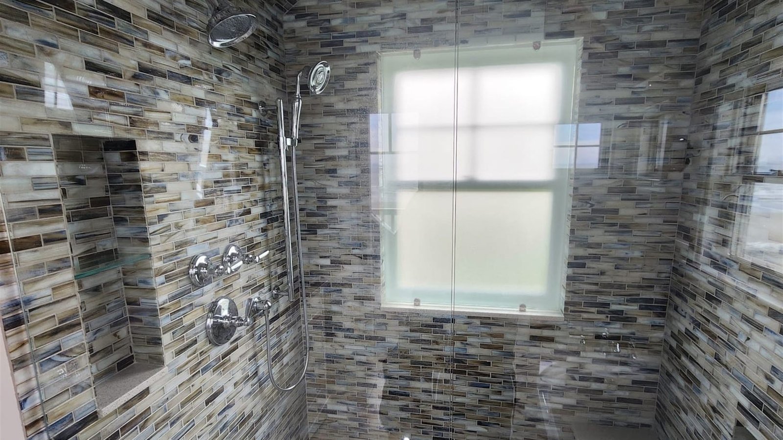 Mosaic tiled shower with grout detailed back to new